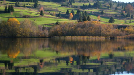 Golden-foliage-reflects-on-the-calm-lake-water
