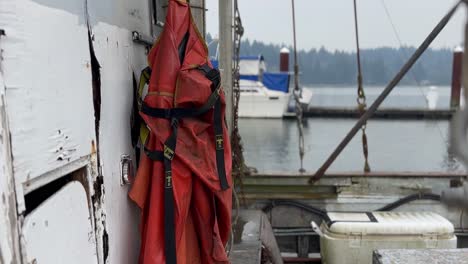 Fishing-Jumpsuit-Hanging-In-A-Trawler-In-Florence,-Oregon
