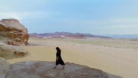 Girl-Traveler-Walking-At-Kharaza-Arch-In-Wadi-Rum-Desert,-Aqaba,-Jordan