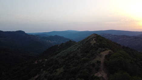A-drone-follows-a-ridge-towards-the-horizon-in-Pico-De-Los-Reales,-Estepona,-Spain