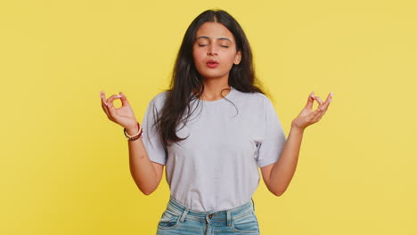 Indian-woman-meditating-breathes-deeply-with-mudra-yoga-gesture,-eyes-closed,-taking-a-break,-relax