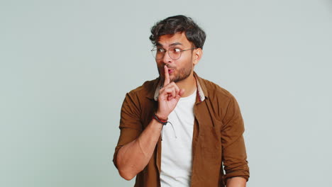 Indian-man-presses-finger-to-lips-make-silence-gesture-sign-do-not-tells-secret-stop-gossip-privacy