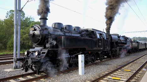 Locomotive-engine-stationary-belching-plumes-of-thick,-black,-acrid-steam