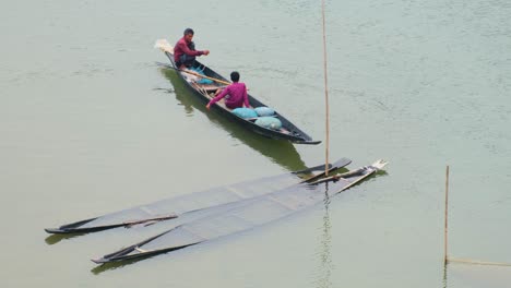 Local-Fishermen-In-Wooden-Boat-At-Tropical-river-In-Bangladesh