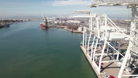 Oakland-Estuary-and-Industrial-Port,-4K-drone-shot-with-shipping-cranes-in-foreground