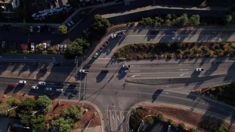 Overhead-aerial-of-traffic-flow-at-suburban-intersection,-Northern-California