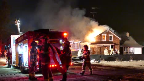 Firemen-fighting-intense-fire-in-burning-house