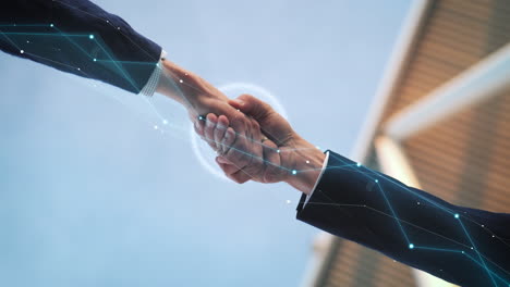 Businessmen-shake-hands-with-digital-network-connections-as-concept-for-successful-deal-and-entering-partnership