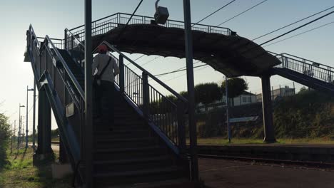 Passenger-heading-over-platform-gap-at-village-railway-station