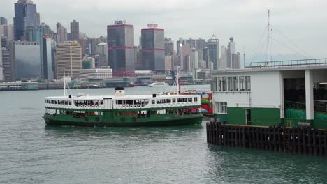 Ferry-sails-along-the-deep-ocean-waters-at-Tsim-Sha-Tsui-waterfront,-Hong-Kong