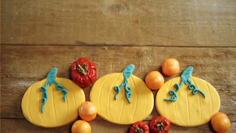 Small-pumpkins,-tomatoes-and-sweet-food-on-a-wooden-table-4k