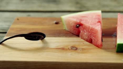 Slices-of-watermelon-arranged-on-chopping-board