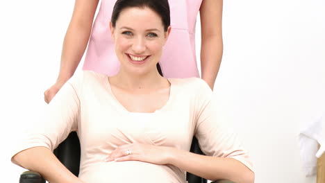Portrait-of-pregnant-woman-sitting-on-wheelchair