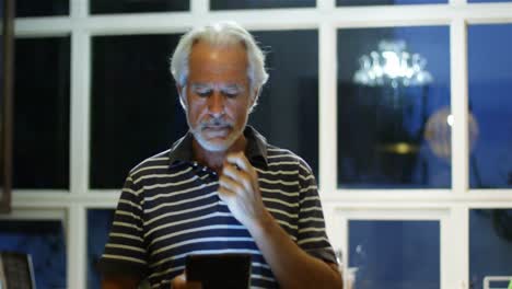 Senior-man-using-digital-tablet-at-home-4k