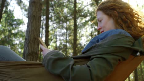 Woman-reading-a-book-in-the-forest-4k