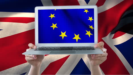 Hands-holding-a-laptop-with-european-flag