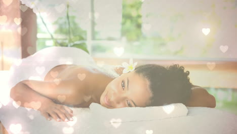 Woman-relaxing-and-lying-at-spa-with-hearts-for-valentine-day
