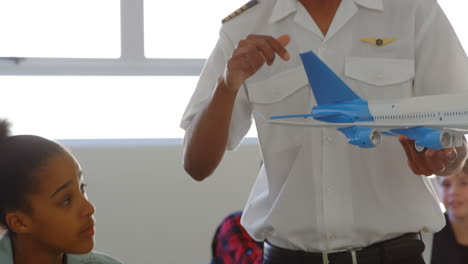 Pilot-giving-training-about-model-aeroplane-to-kid-4k