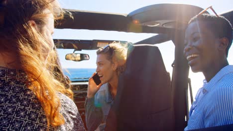 Group-of-female-friends-interacting-each-other-in-the-car-4k