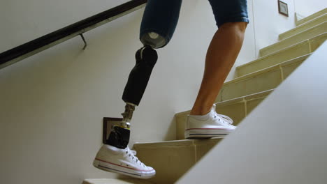 Disabled-woman-with-prosthetic-leg-moving-upstairs-4k
