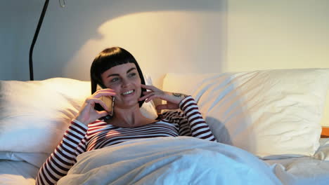 Woman-talking-on-mobile-phone-in-bedroom-4k