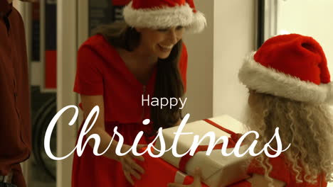 Happy-Christmas-text-and-mother-and-father-giving-present-to-her-daughter-4k