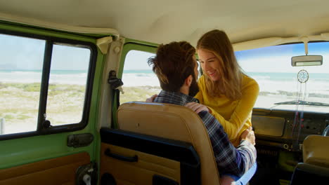 Happy-young-woman-sitting-on-mans-lap-in-van-on-a-sunny-day-4k