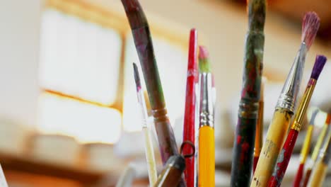 Close-up-of-various-paint-brush-in-pencil-holder-4k