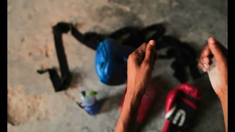 African-American-male-boxer-dusting-chalk-powder-in-fitness-studio-4k