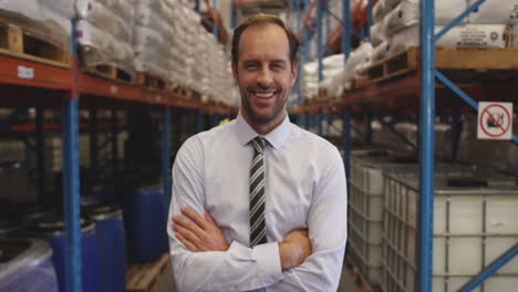 Portrait-of-male-manager-smiling-in-a-warehouse-4k