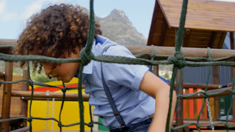 Side-view-of-mixed-race-schoolgirl-playing-in-school-playground-on-a-sunny-day-4k