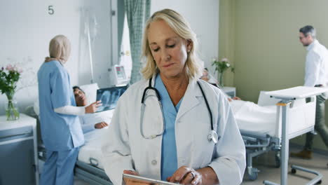 Female-doctor-using-tablet-computer-in-hospital-ward-4k