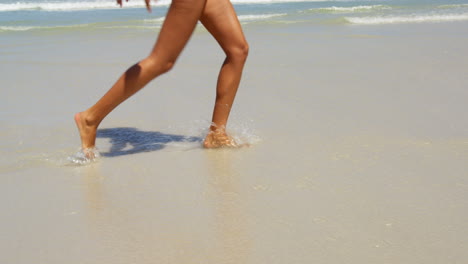 Woman-having-fun-at-beach-on-a-sunny-day-4k