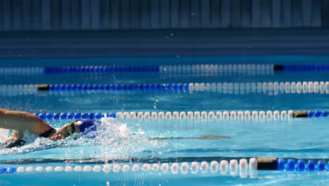 Female-swimmer-swimming-inside-pool-4k