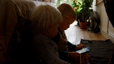 Siblings-using-digital-tablet-at-home-4k
