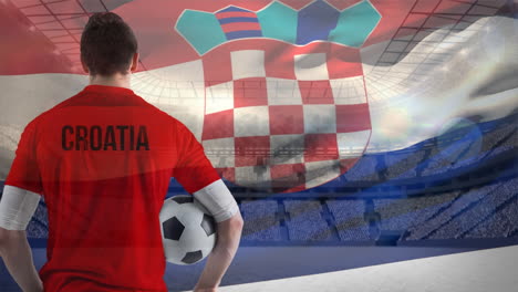 Jugador-De-Fútbol-Croata-Sosteniendo-El-Balón-Frente-Al-Estadio