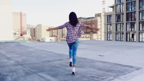 Fashionable-young-woman-on-urban-rooftop-running