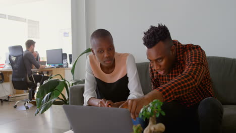 Front-view-of-young-black-business-team-planning-and-sitting-the-on-couch-in-office-4k