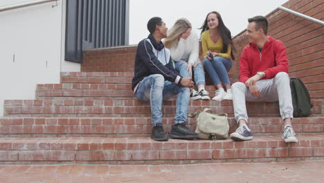Friends-laughing-together-outside-in-high-school-