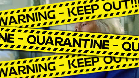 Words-Keep-out,-Quarantine-written-on-yellow-tape-over-a-senior-female-patient.-Covid-19-spreading