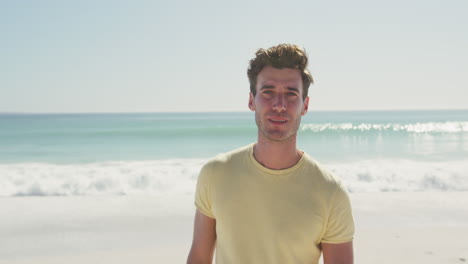 Caucasian-man-looking-at-the-camera-at-beach-