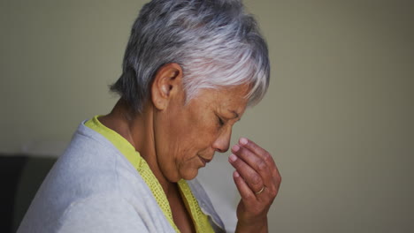 Seniorin-Mit-Gemischter-Abstammung-Sitzt-Mit-Kopfschmerzen-Und-Berührt-Die-Stirn