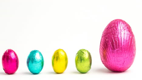 Animation-of-pink,-yellow-and-blue-easter-eggs-on-white-background