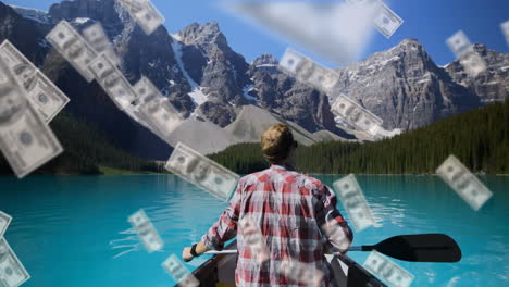 Animation-of-american-dollar-bills-falling-over-caucasian-man-canoeing-on-lake