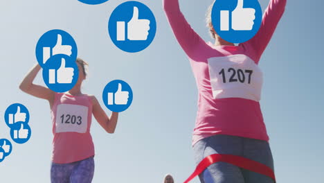 Animation-of-social-media-thumbs-up-like-symbols,-over-female-runners-finishing-race