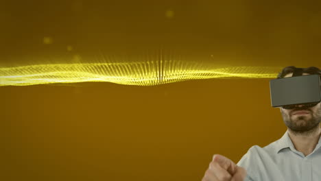 Caucasian-man-wearing-vr-headset-against-golden-digital-waves-and-light-spots-on-yellow-background