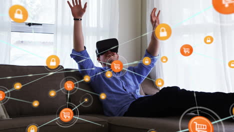 Animation-of-network-of-connections-with-icons-over-businessman-wearing-vr-headset
