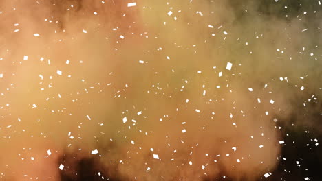Animation-of-white-confetti,-yellow-and-orange-powder-falling,-on-black-background