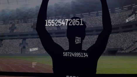 Multiple-changing-numbers-over-silhouette-of-male-athlete-celebrating-against-sports-stadium