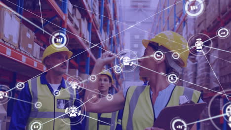 Network-of-digital-icons-against-team-of-male-and-female-workers-checking-stock-at-warehouse